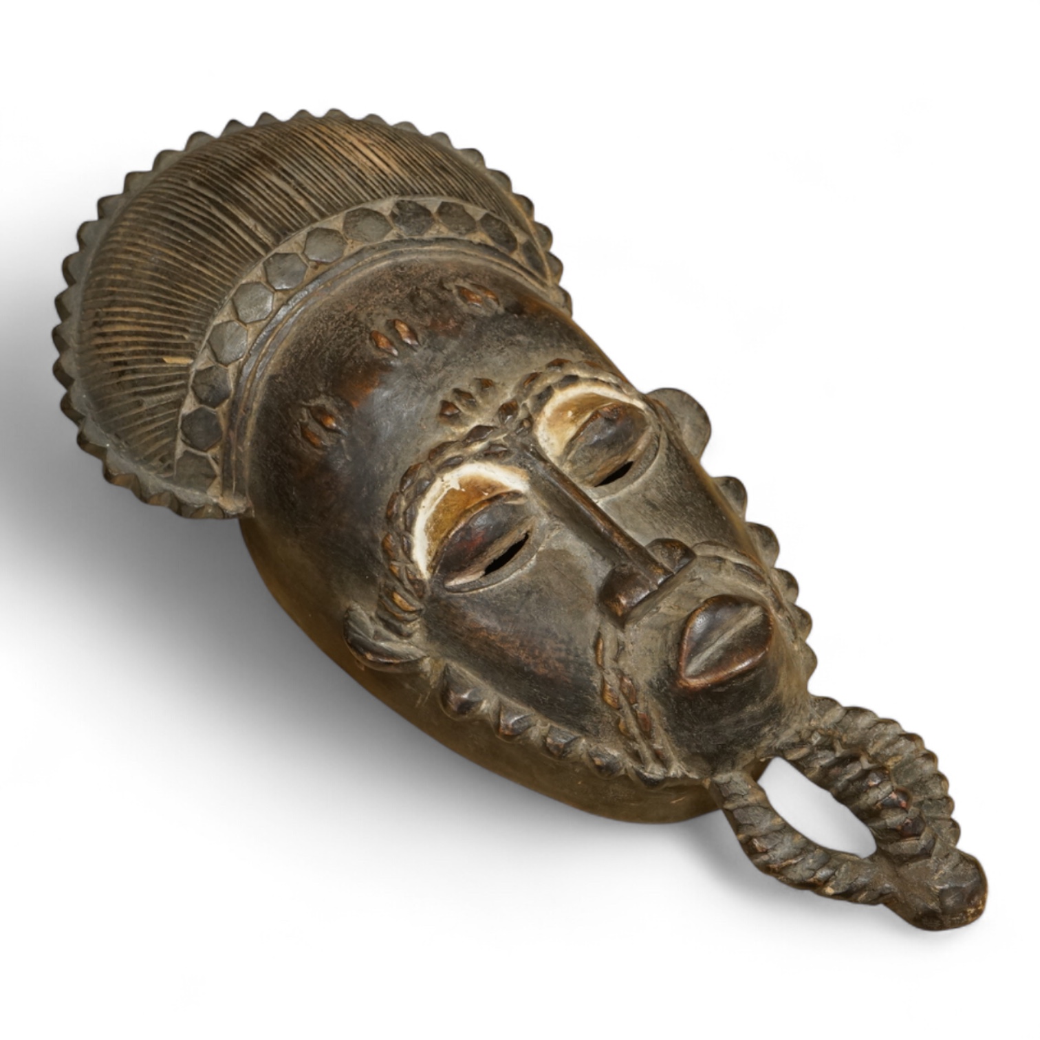 A carved African Guro mask from the Ivory Coast, 40cm long.